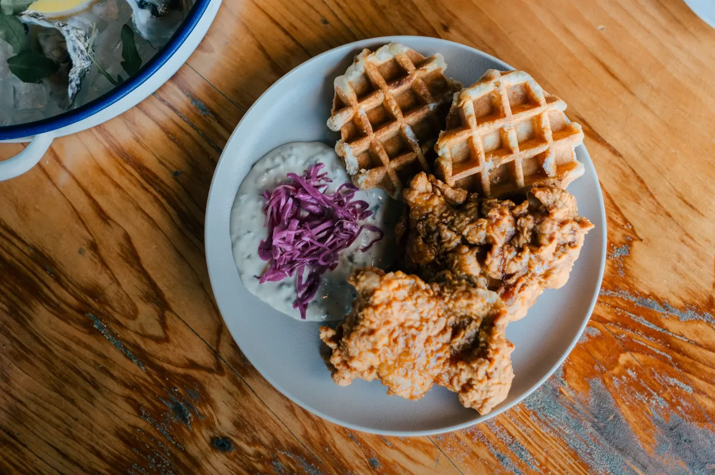 Chicken and waffles with slaw on a wooden table