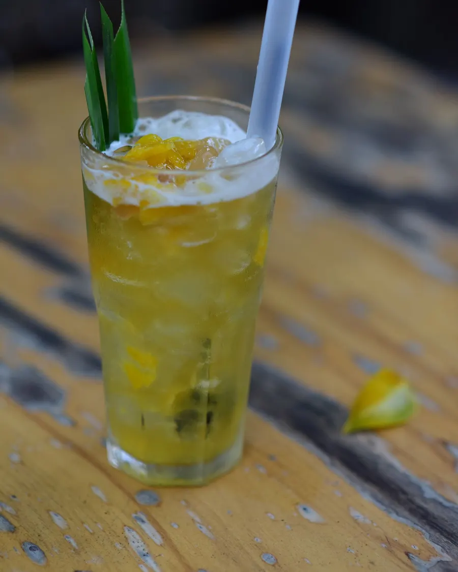 Tall glass of pineapple soda over ice