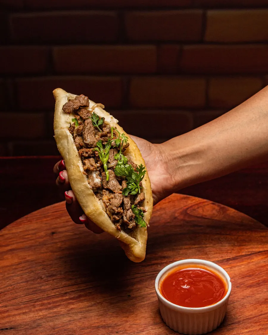 Bread stuffed with sliced seasoned steak and herbs