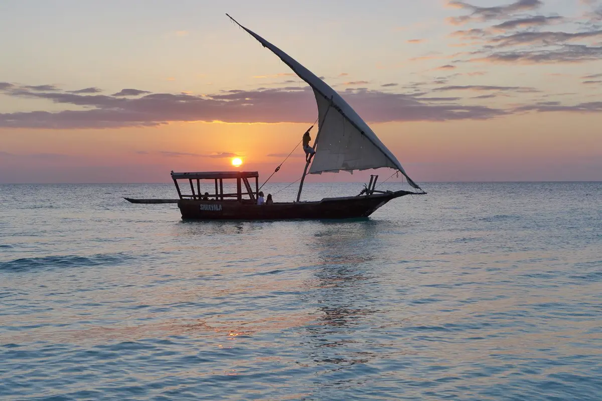 A dhow sailing at sunset