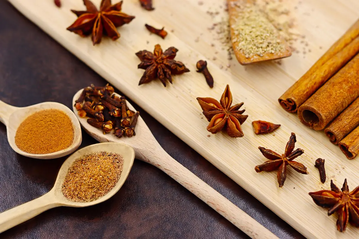 Cinnamon, cloves and star anise on a wooden board