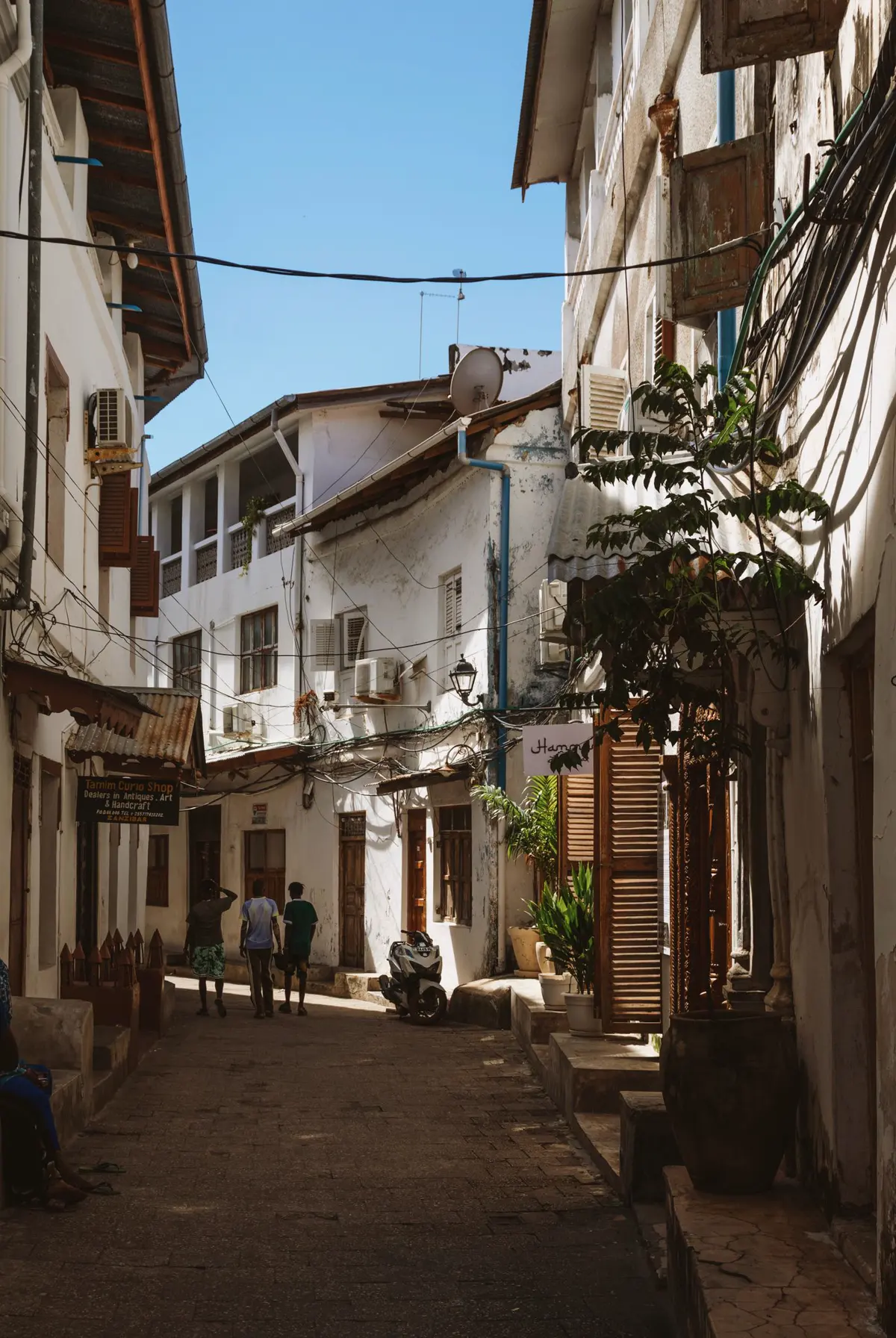 A narrow street in Stone Town with old coral-stone houses